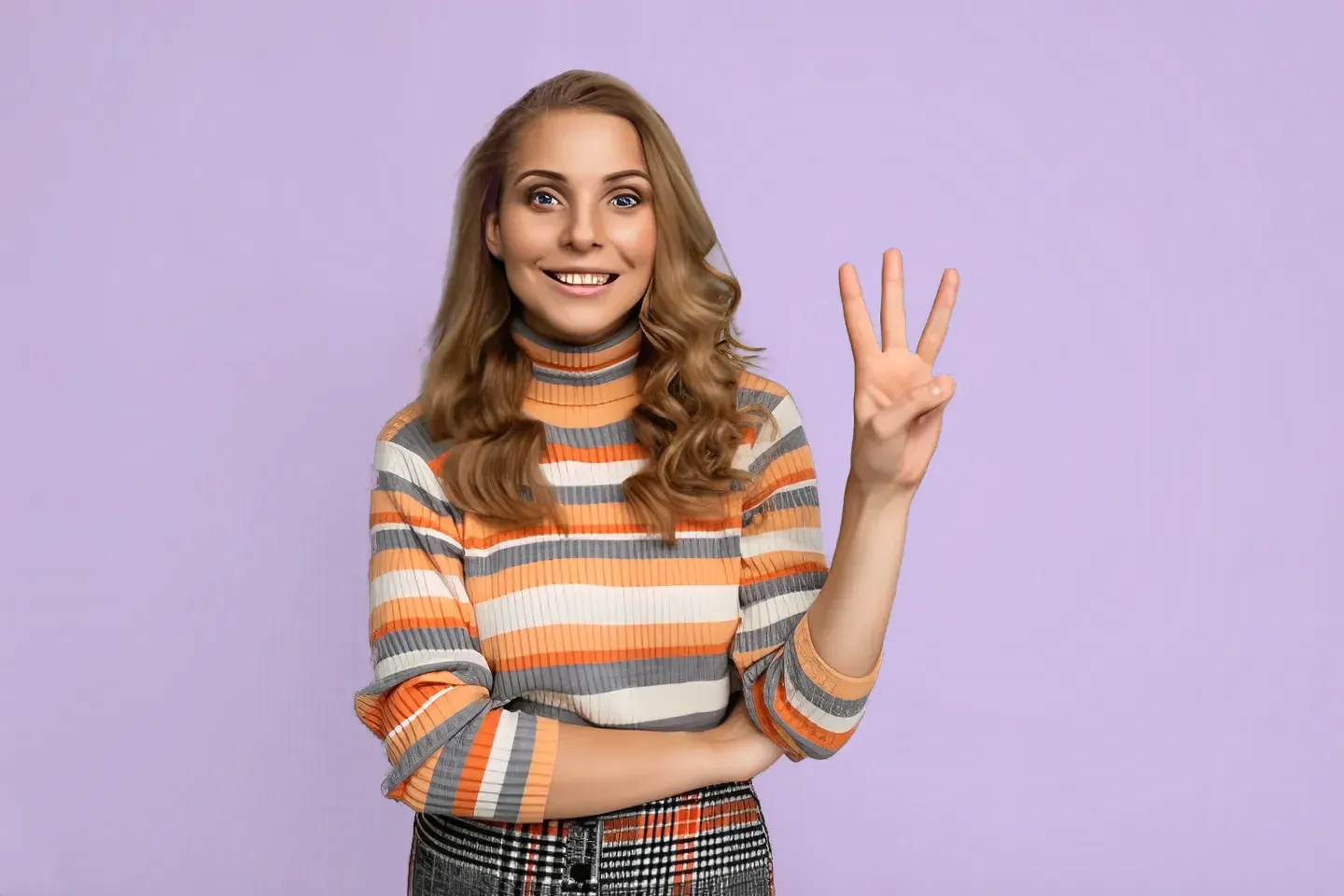 A smiling woman holding up three fingers