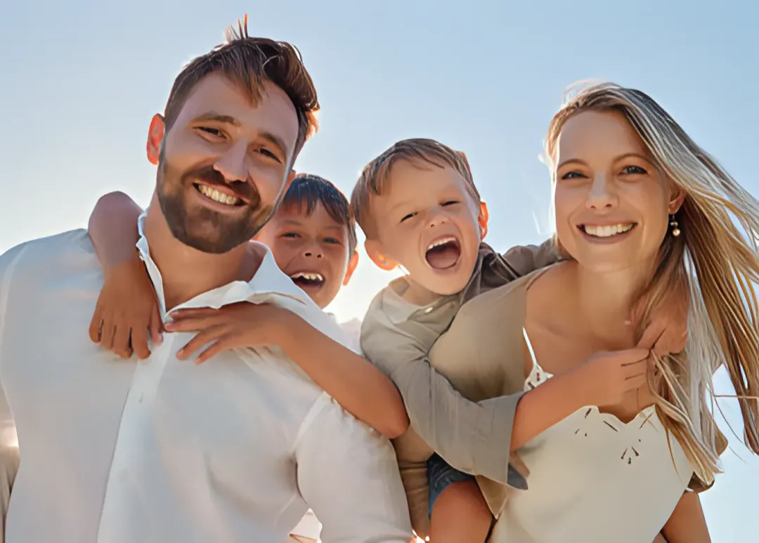 A multi-generational family standing together outdoors, representing hope and connection after mental health treatment